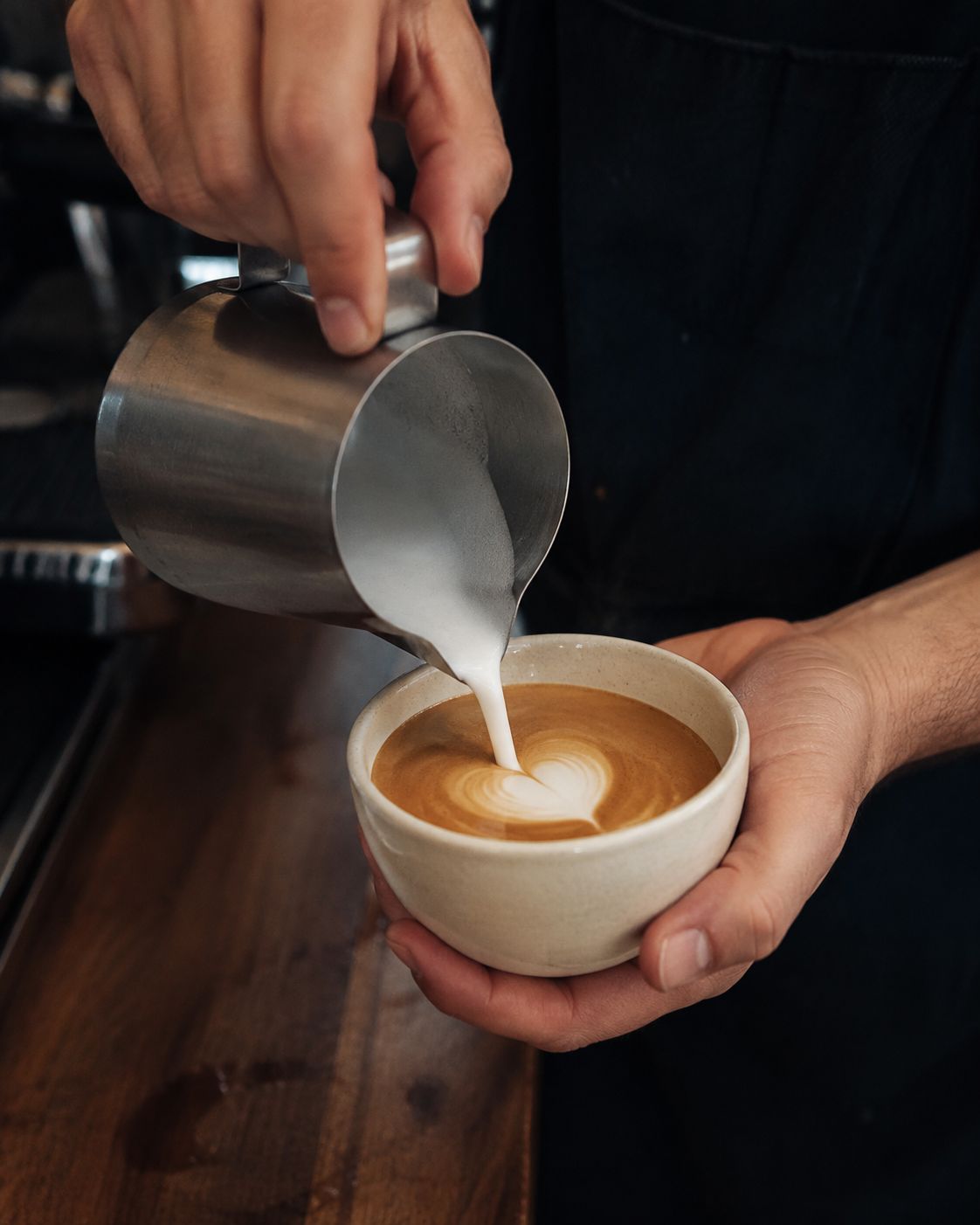 Barista pouring latte art for a product launch experience